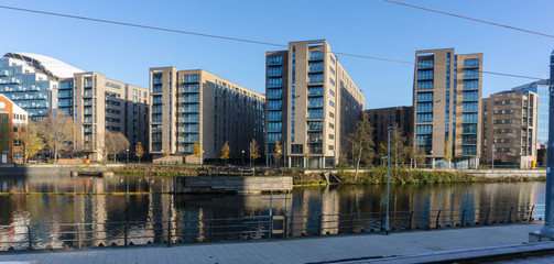 New residential apartment blocks on former docklands over-looking the water © iammattdoran