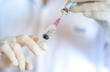 Syringe medical injection in hand holding with medicine dose vaccination equipment with needle.
