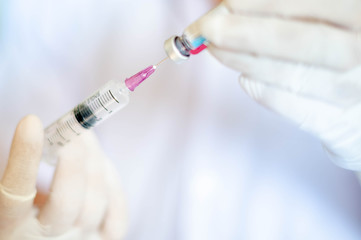 Syringe medical injection in hand holding with medicine dose vaccination equipment with needle.