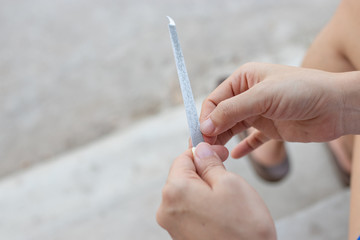 Close up of woman doing a manicure with a nail file.