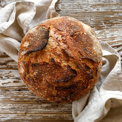 Artisan sourdough bread on a wooden table, top view