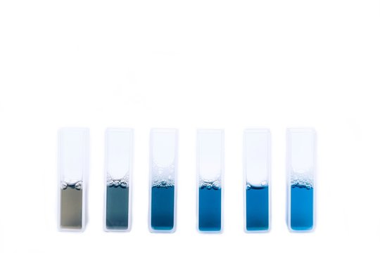 Liquid reagent in quartz or glass cuvettes isolated on white background.