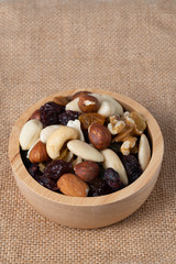 Mixed nut and raisin snack in wooden bowl