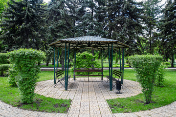 Metal gazebo in the city park in spring.