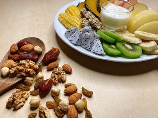 Fruits and Nutty with fresh yogurt, kiwi, apple, Chinese pear, dragon fruit, corn and banana