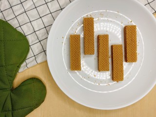 Baked crispy chocolate and coffee Wafers on white plate.