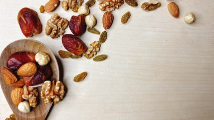 Nutty background, dates, walnuts, almonds, hazelnuts, raisins.