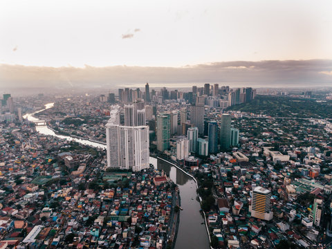 Aerial Cityscape shot of the Makati City in Manila, Philippines while sunrise