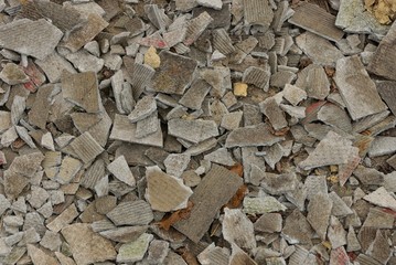 gray background of broken pieces of slate in a pile of garbage