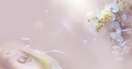 Wedding background with rings and flowers.