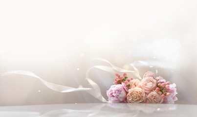 Wedding background with a bouquet of roses and a white ribbon