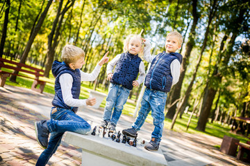 Funny three children, a large family of Caucasian ethnicity play on a public chess platform in a city park. Children frolic and indulge instead of studying. The topic of hyperactivity in children