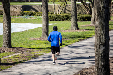 Chicago,IL/USA-April 18th 2020: People are enjoying walks in the parks of downtown Chicago wearing...