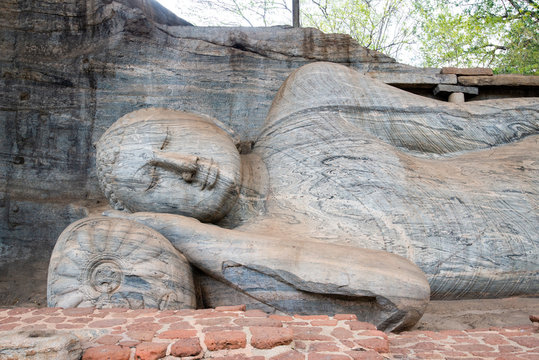 Beautiful face of reclining Buddha is 14 m long, picturing Buddha entering Nirvana at Gal Vihara in ancient city of Polonnaruwa, Sri Lanka.