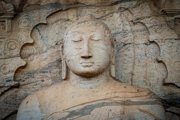 Fototapeta na wymiar Beautiful face of Buddha at Gal Vihara. This is an unusual feature in ancient Sinhalese sculpture in ancient city of Polonnaruwa. Gal Vihara is a group of four beautiful Buddhas carved by granite.
