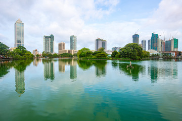 Fototapeta na wymiar View of Colombo cityscape and skyscrapers reflection on Beira Lake a lake in the center of the city. Colombo is the commercial capital and largest city of Sri Lanka.