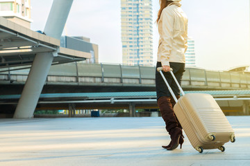 Woman tourism walking with suitcase in city.