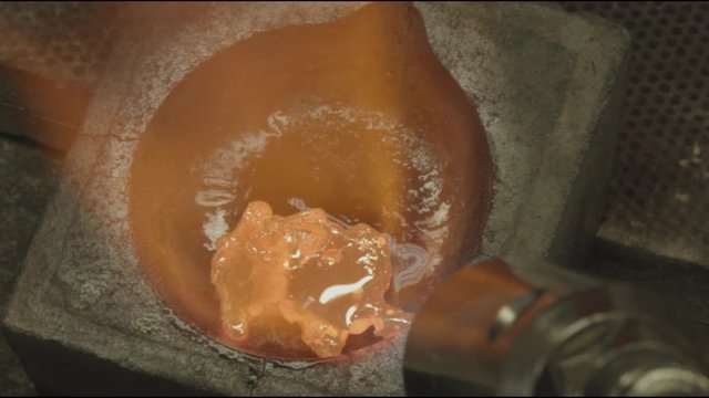 Goldsmith melting metal: silver, gold, with gas torch