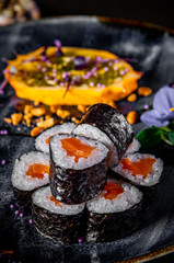 sushi roll with salmon and rice in plate