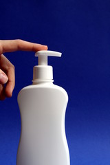 Female hands squeeze disinfectant liquid from a bottle