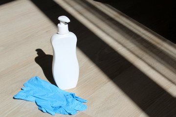 Disinfection tube with blue gloves for surface disinfection