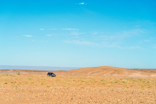 Driving off road through vast Sahara Desert in Morocco
