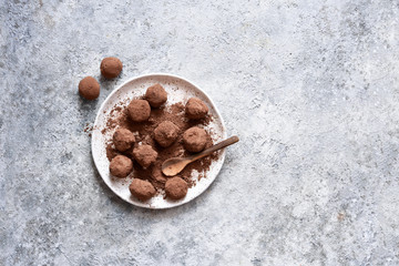 Chocolate truffle with cocoa powder on a concrete background. View from above.