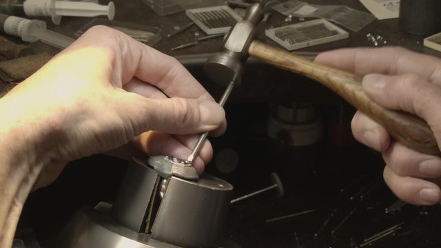 Jewelry Work. Processing Of Gold Ring with small hammer
