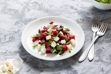 Baked beets with feta cheese and shoots of young peas