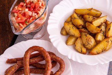 portion of roasted potatoes and sausage and vinaigrette