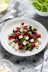 Baked beets with feta cheese and shoots of young peas