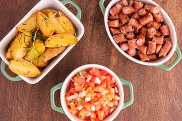 portion of roasted potatoes and sausage and vinaigrette