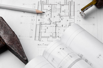 House construction plan. Hammer and measuring cup.