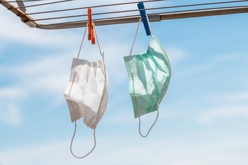 Protective Medical mask hung on the clothes line during Covid-19 coronavirus pandemic quarantine