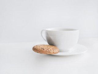 Cup of coffee Top view photo with copy space Homemade coffee in a white cup and oatmeal cookie with chocolate chips on the white table