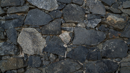 Natural stone wall texture. Medieval masonry. Ancient wall. Stone brick wall. Macro texture. Medieval architecture. Rough masonry. Background texture.