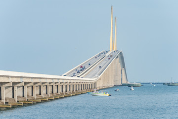 Approach to Skyway Bridge with boaters fishing on one side - obrazy, fototapety, plakaty