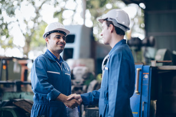 professional technician engineer shake hand in factory