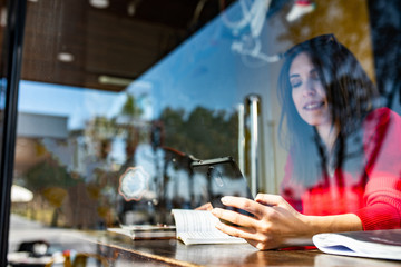 Beautiful young woman having Zoom video conference call via smart phone. Zoom Call Meeting. During Covid-19 Coronavirus pandemic