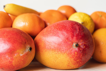 Still-life with mango and citrus close up on white background, isolated. Tasty fruits are natural products and healthy food.