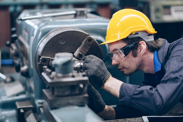 technician engineer checking metal on machinery in factory