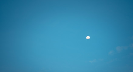 White moon against the blue sky