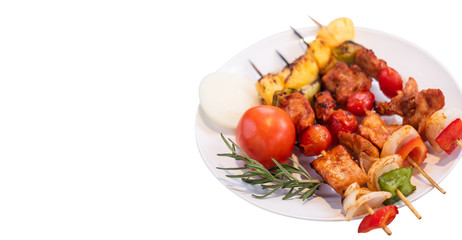 Juicy delicious BBQ Grilled with pork ,sausage,tomato,onion,pineapple,chilli Skewers in plate on isolated white  background.