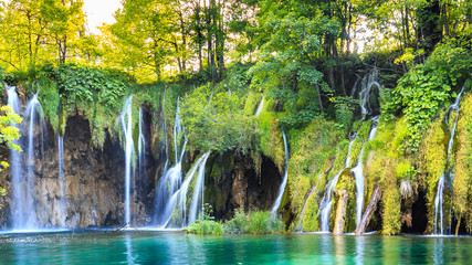 Close up of blue waterfalls in a green forest during daytime in Summer.Plitvice lakes, Croatia - Powered by Adobe