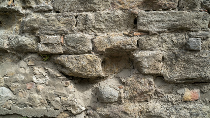 Natural stone wall texture. Medieval masonry. Ancient wall. Stone brick wall. Macro texture. Medieval architecture. Rough masonry. Background texture.