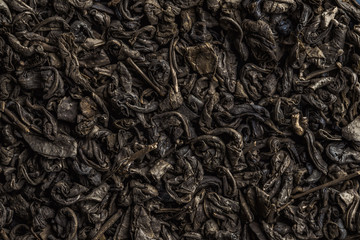 Texture of tea. Dry green tea leaves. 