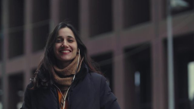 Portrait of Young Indian Woman Listening to Earphones and Singing