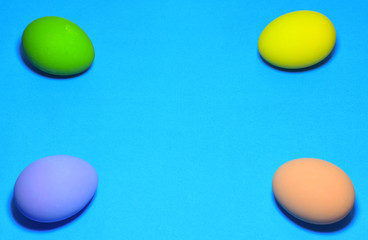 Easter eggs and text space on a blue background.