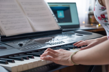 Playing a musical instrument at home, synthesizer and piano