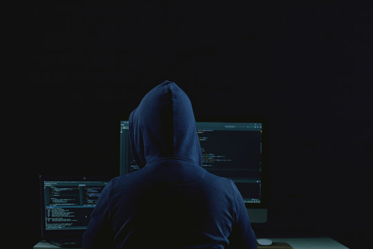young guy behind a laptop, a hacker
